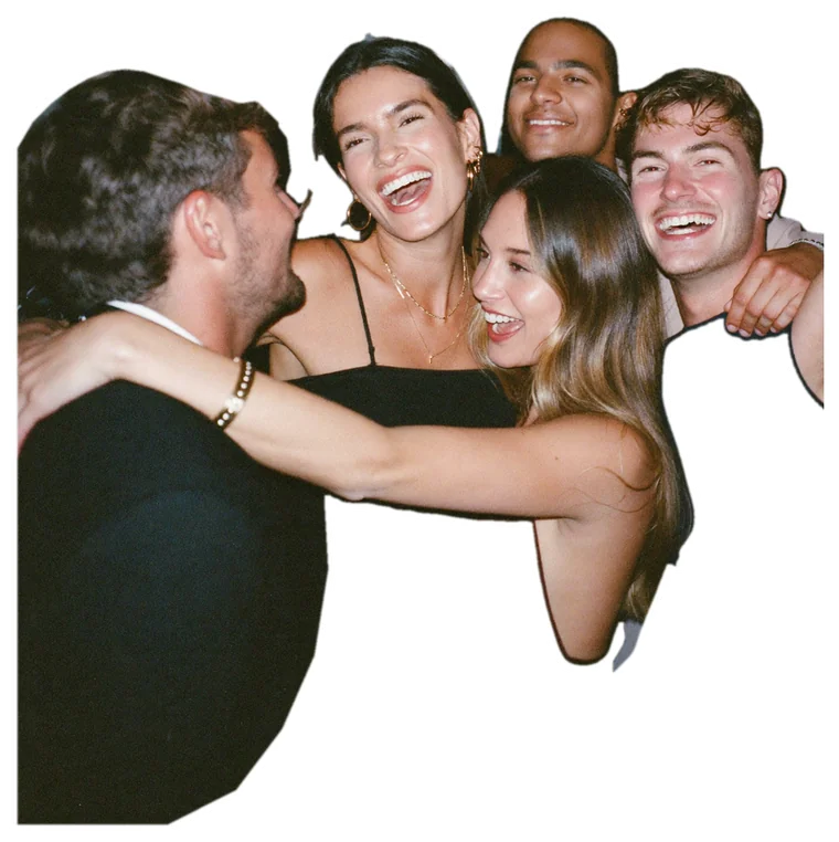 Friends with their arms around each other, laughing
